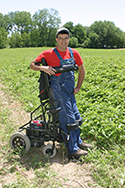 Ed Bell, a strawberry farmer in a standing wheelchair